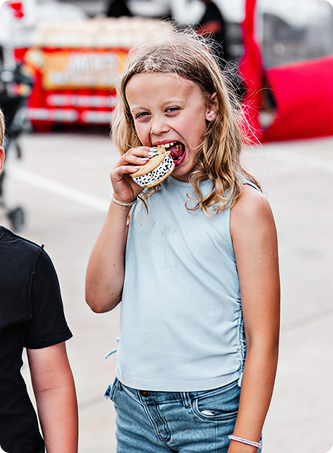 Girl taking a bite out of a Blue Bunny Ice Cream Sandwich