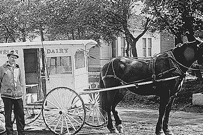 Horse Drawn Carriage with Wells Dairy written on the side