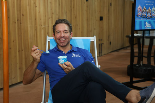 Man sitting in a beach chair eating ice cream