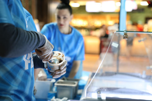 Man scooping up ice cream