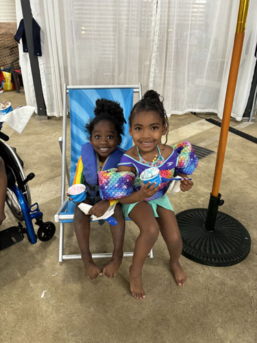 Two girls smiling holding their ice cream