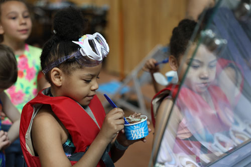 Girl digging into her cup of ice cream