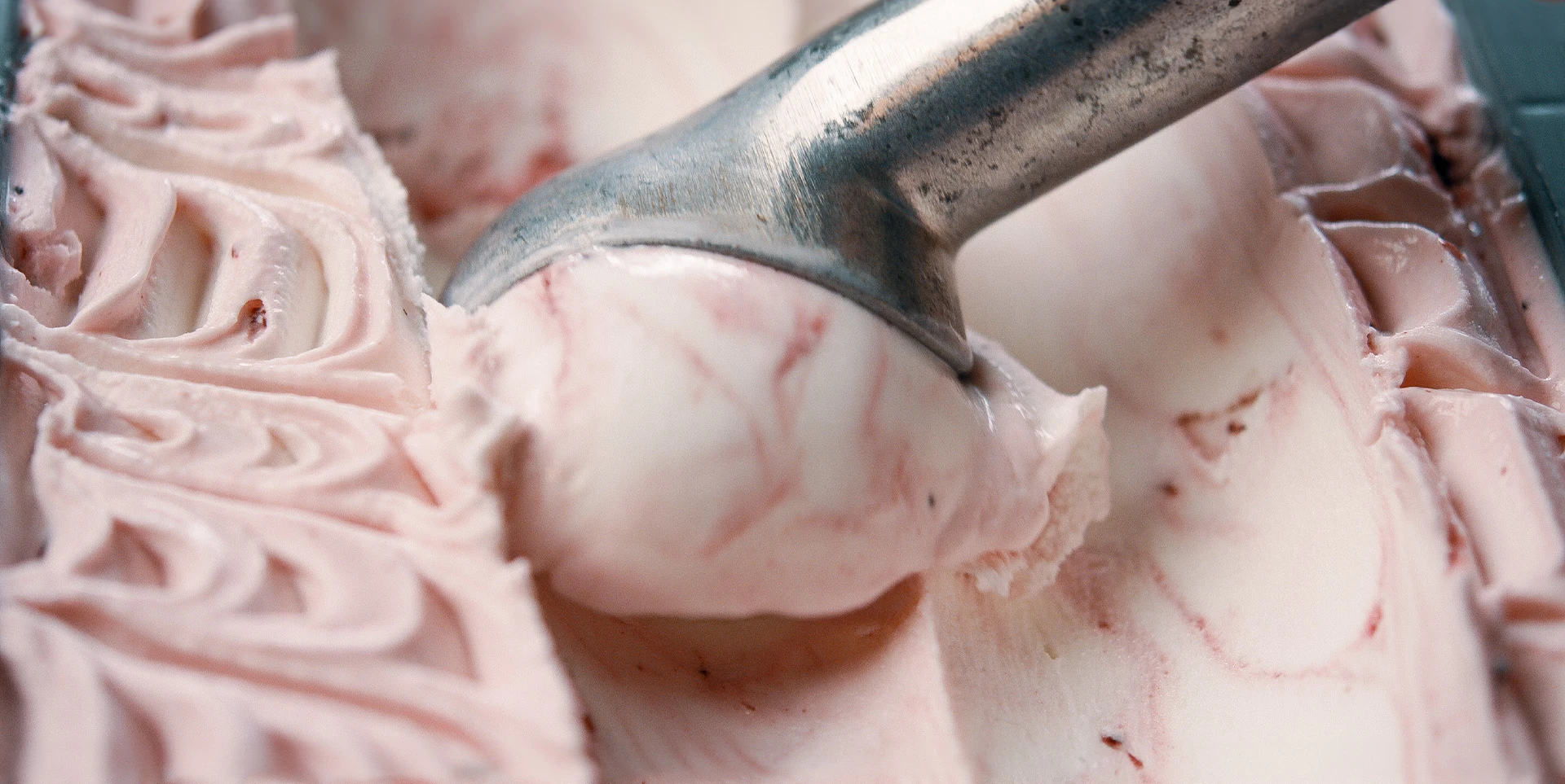 Scooping ice cream out of a tub