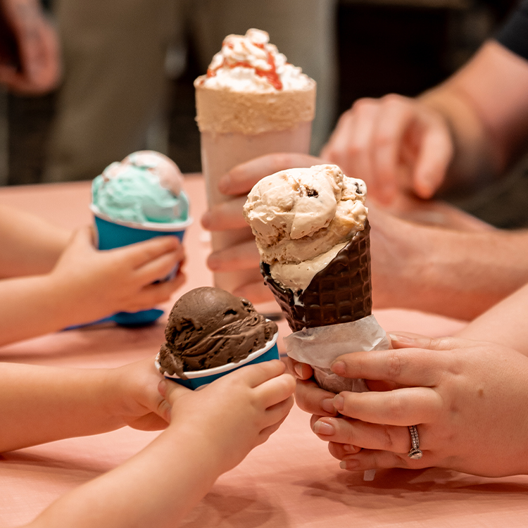 Four people holding cones