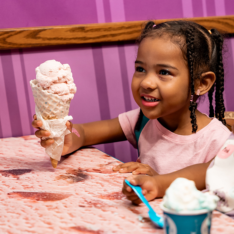 Girl holding a cone smiling